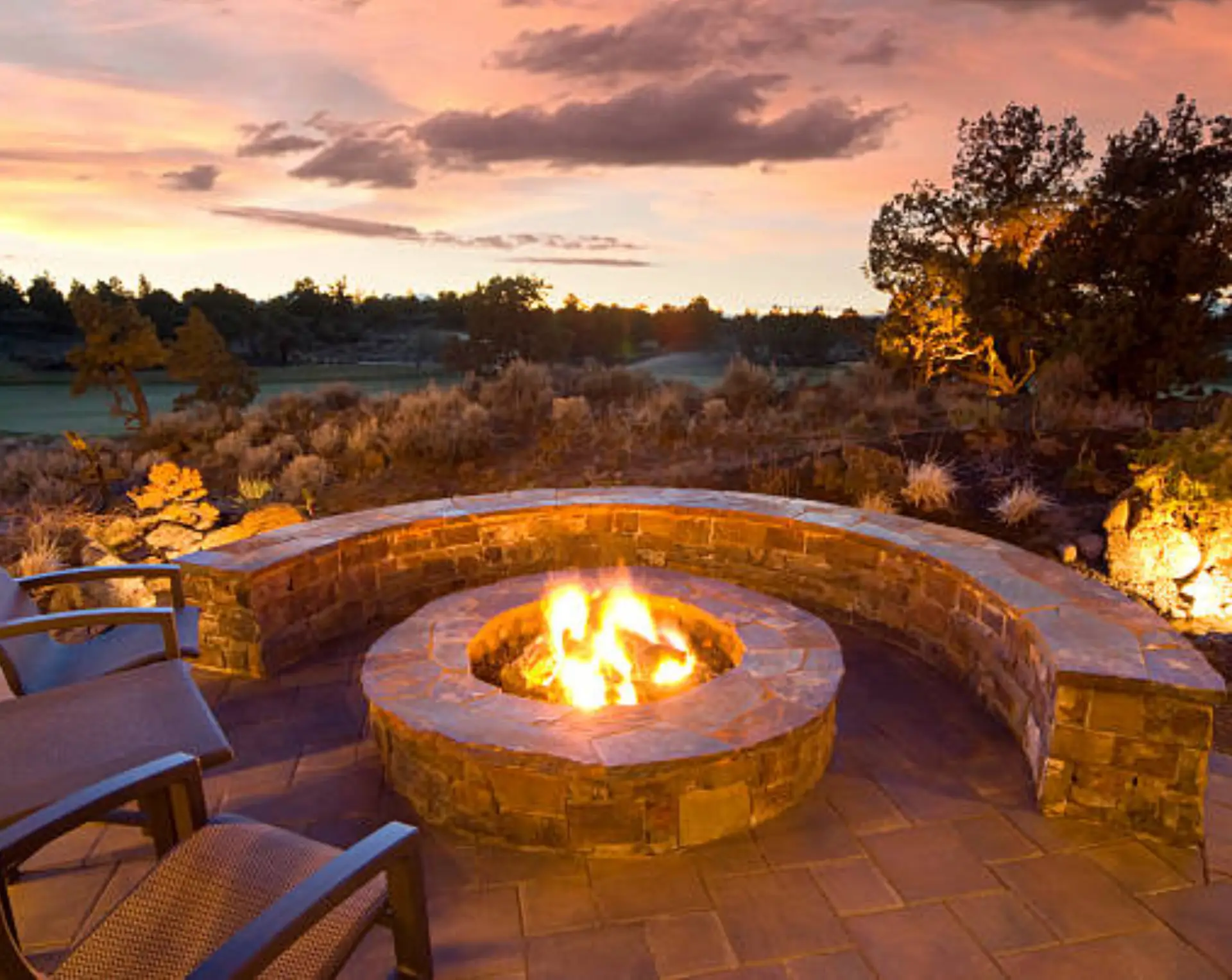 Circular stone fire pit at dusk